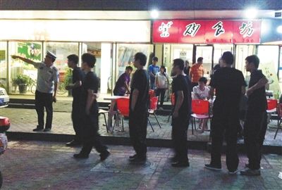 6月13日晚10點，朝陽區(qū)國美第一城附近，一名城管隊員帶領(lǐng)一隊協(xié)管例行巡查街邊大排檔。新京報記者 尹亞飛 攝