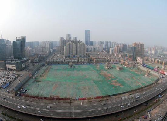 2016年4月，經(jīng)過持續(xù)攻堅，親賢社區(qū)西北片區(qū)的拆遷工作基本告一段落，但在鋪設(shè)了防塵綠網(wǎng)的空地中，至今仍有3戶居民選擇了“堅守”。(拍攝：2016年4月4日)