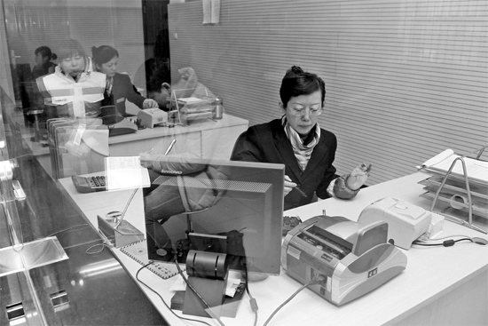 2月16日，鄭州市自來水總公司鄭東新區(qū)一營業(yè)廳，柜臺(tái)內(nèi)工作人員正在為市民辦理業(yè)務(wù)