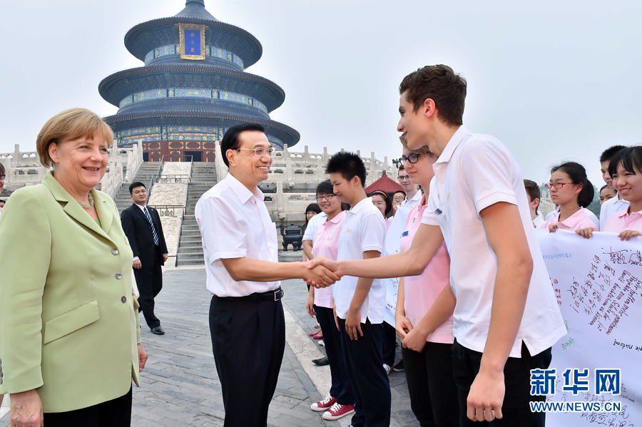 李克強同默克爾與青少年代表親切交流。