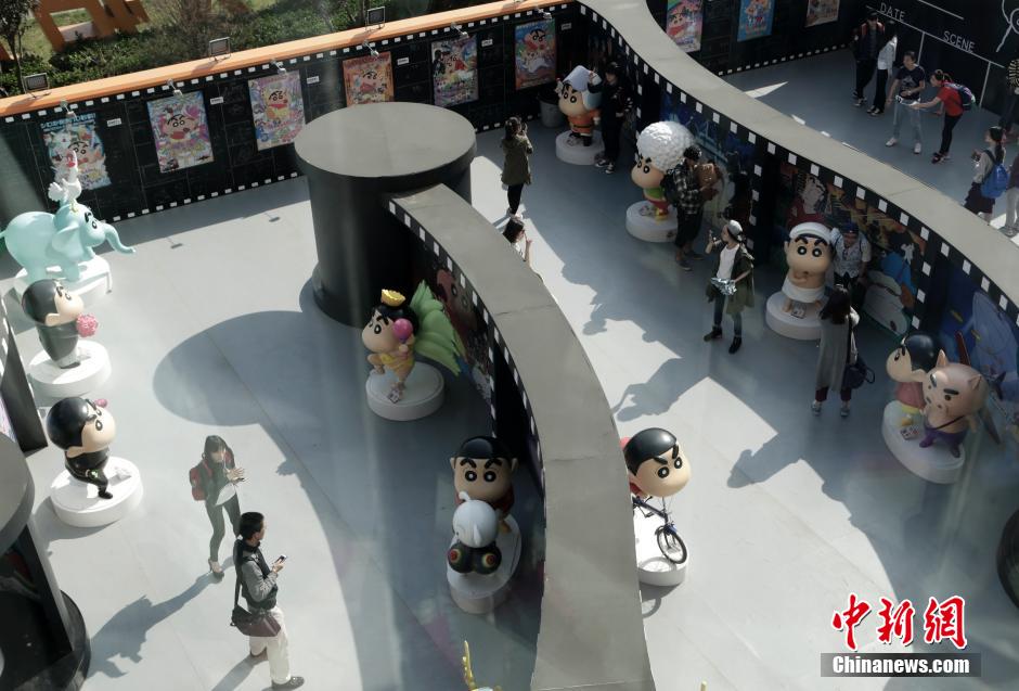 4月22日，游客與蠟筆小新合影?！跋灩P小新25周年紀(jì)念特展”日前在北京開(kāi)展，吸引了不少市民游客。