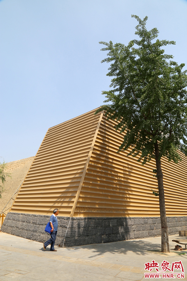 一名路人從“土豪金”保護殼前經(jīng)過。