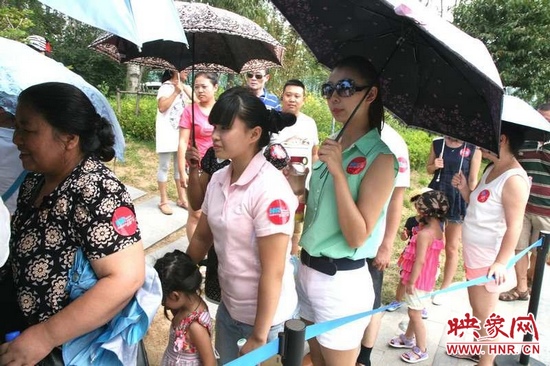 佩戴信息廣播臂貼的聽眾們?cè)谂抨?duì)等候坐帆船。